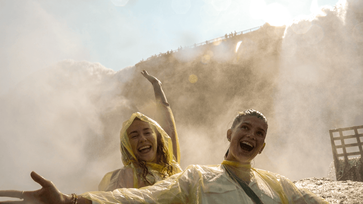 Guides in yellow ponchos on wooden walkways at Cave of the Winds.