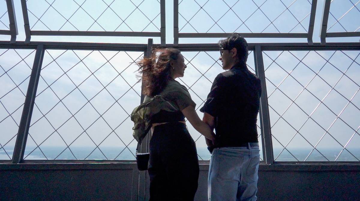 Couple holding hands at Skylon Tower observation deck
