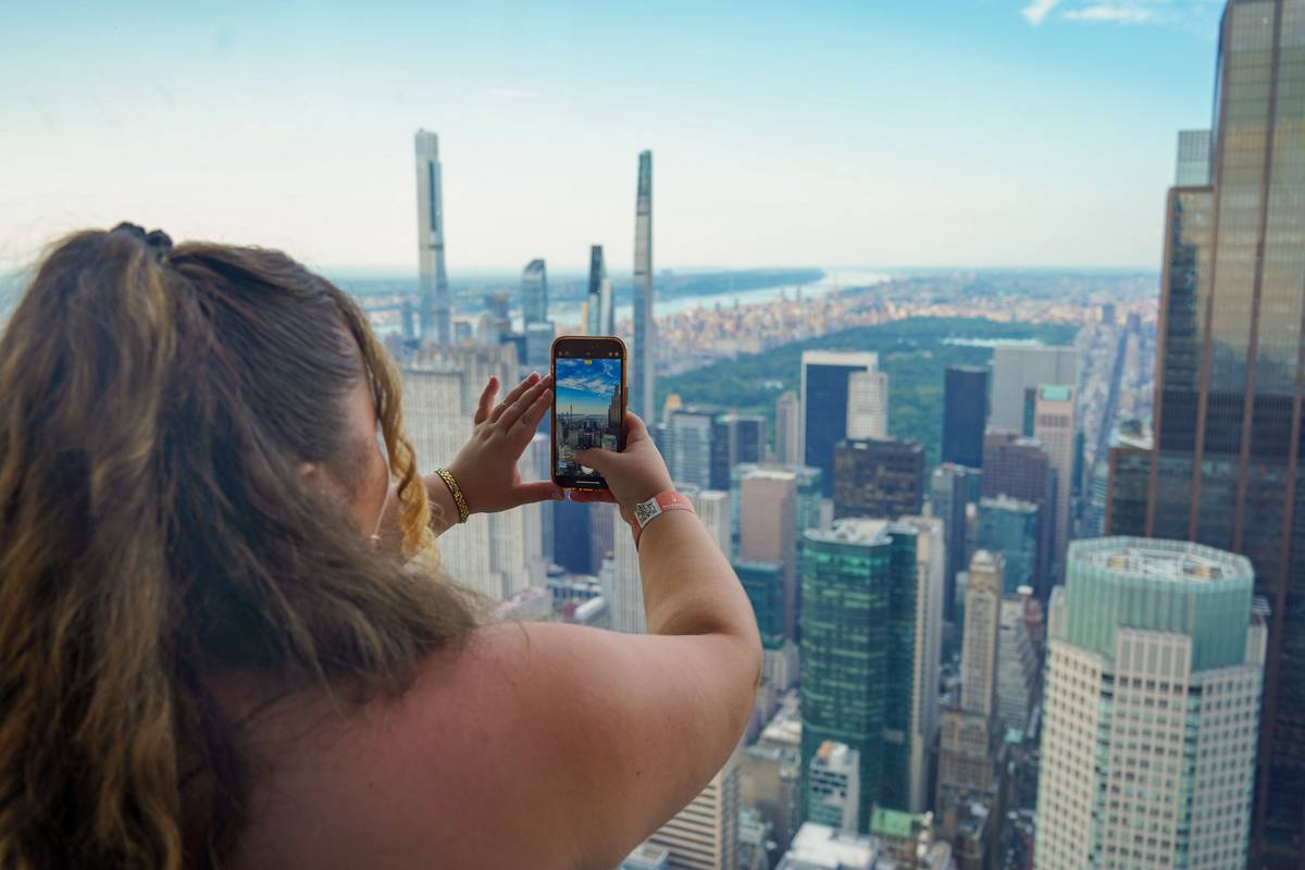 Visitor taking photo of NYC skyline from Summit Vanderbilt.