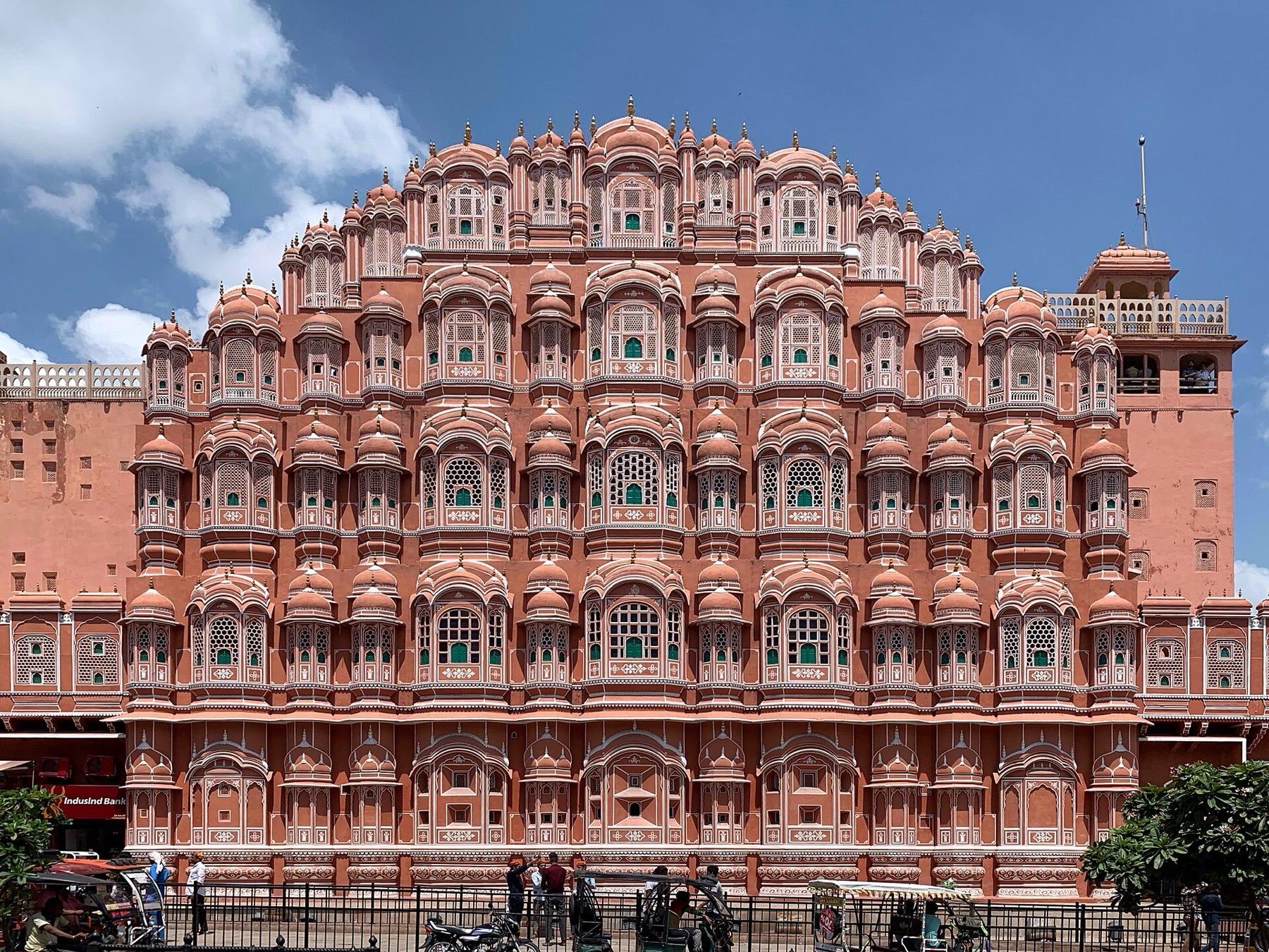 The pink sandstone east facade of the Hawa Mahal in Jaipur, rising in tiers of small latticed windows