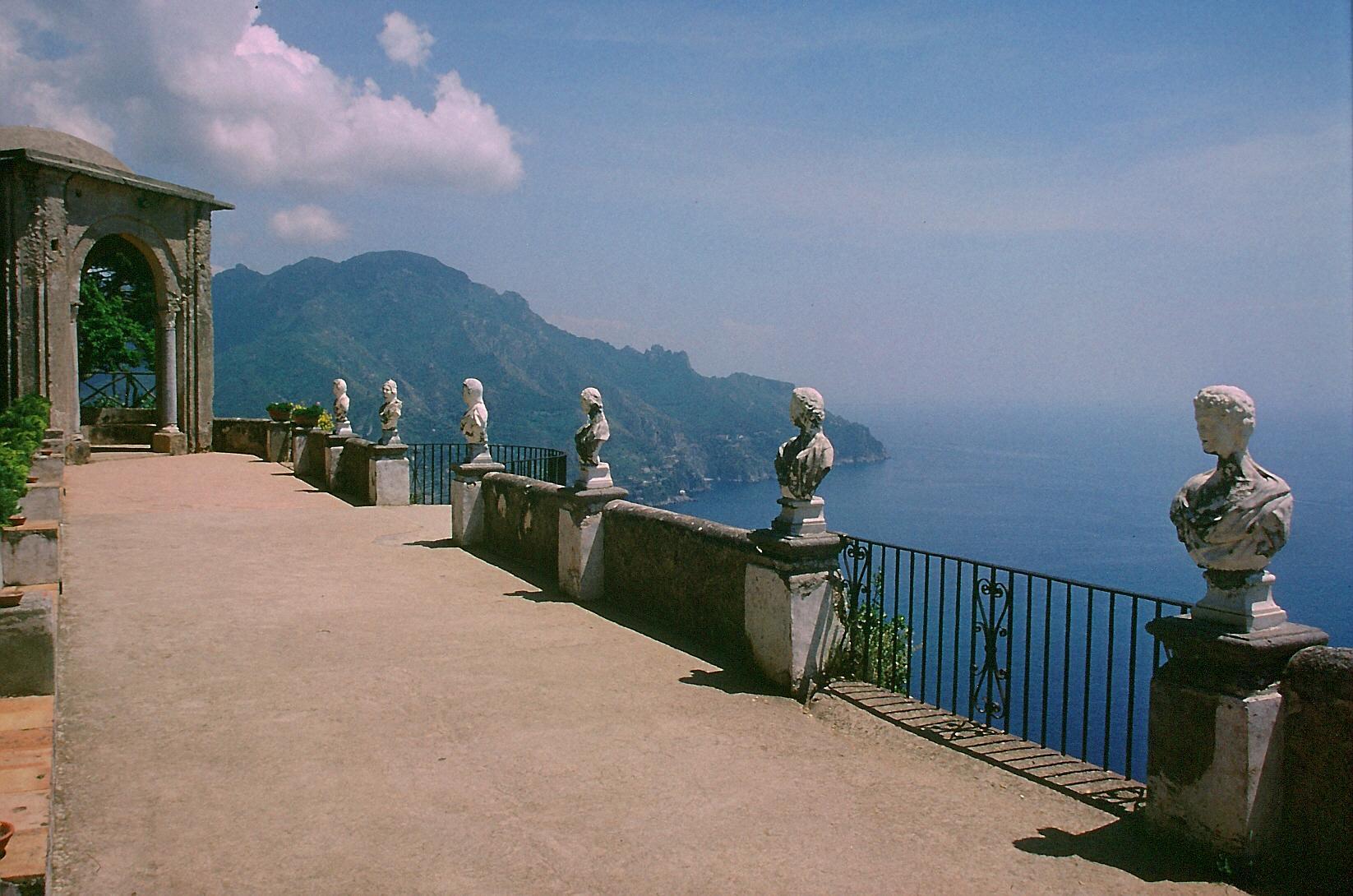 The Terrace of Infinity at Villa Cimbrone in Ravello, a row of marble busts on a balustrade high above the sea and the mountains of the coast