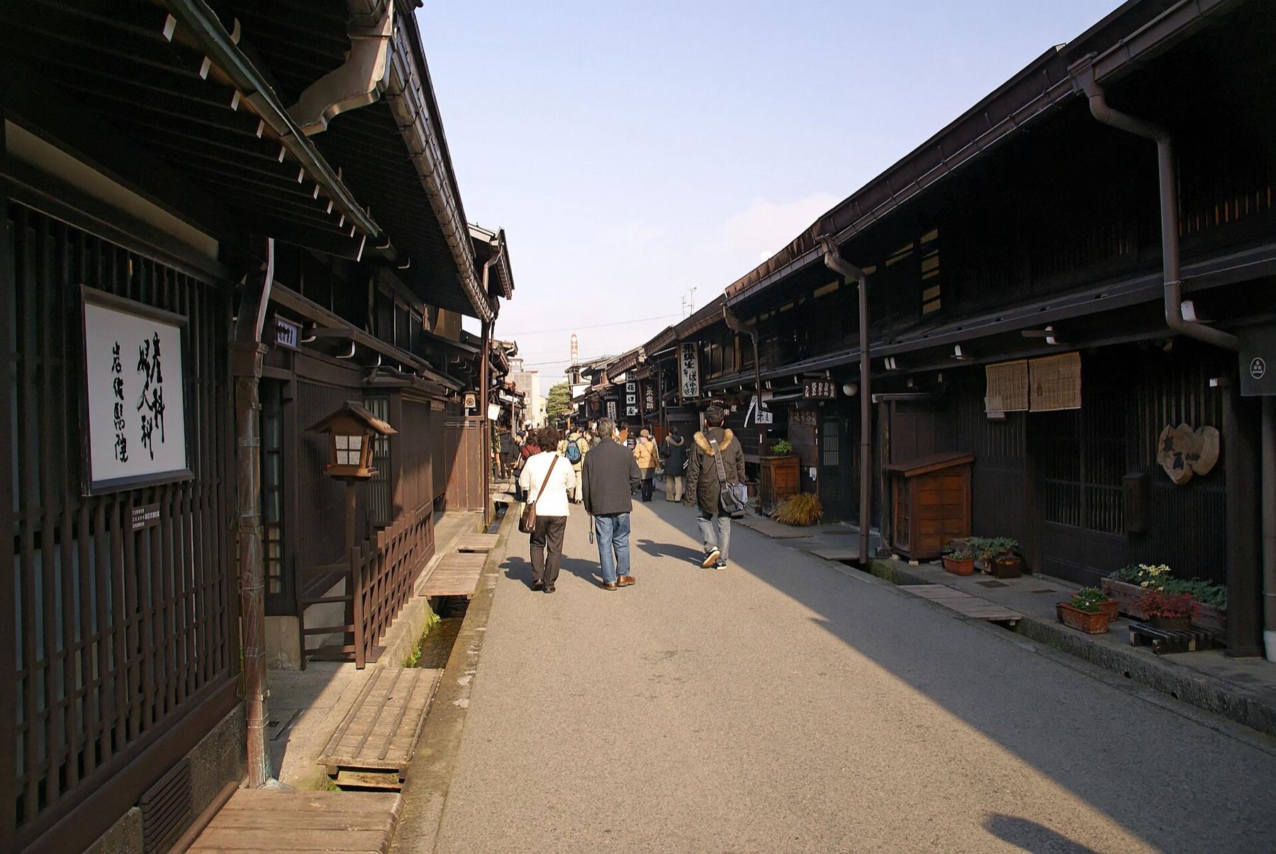 A lane of dark wooden Edo-period merchant houses in Sanmachi Suji, Takayama