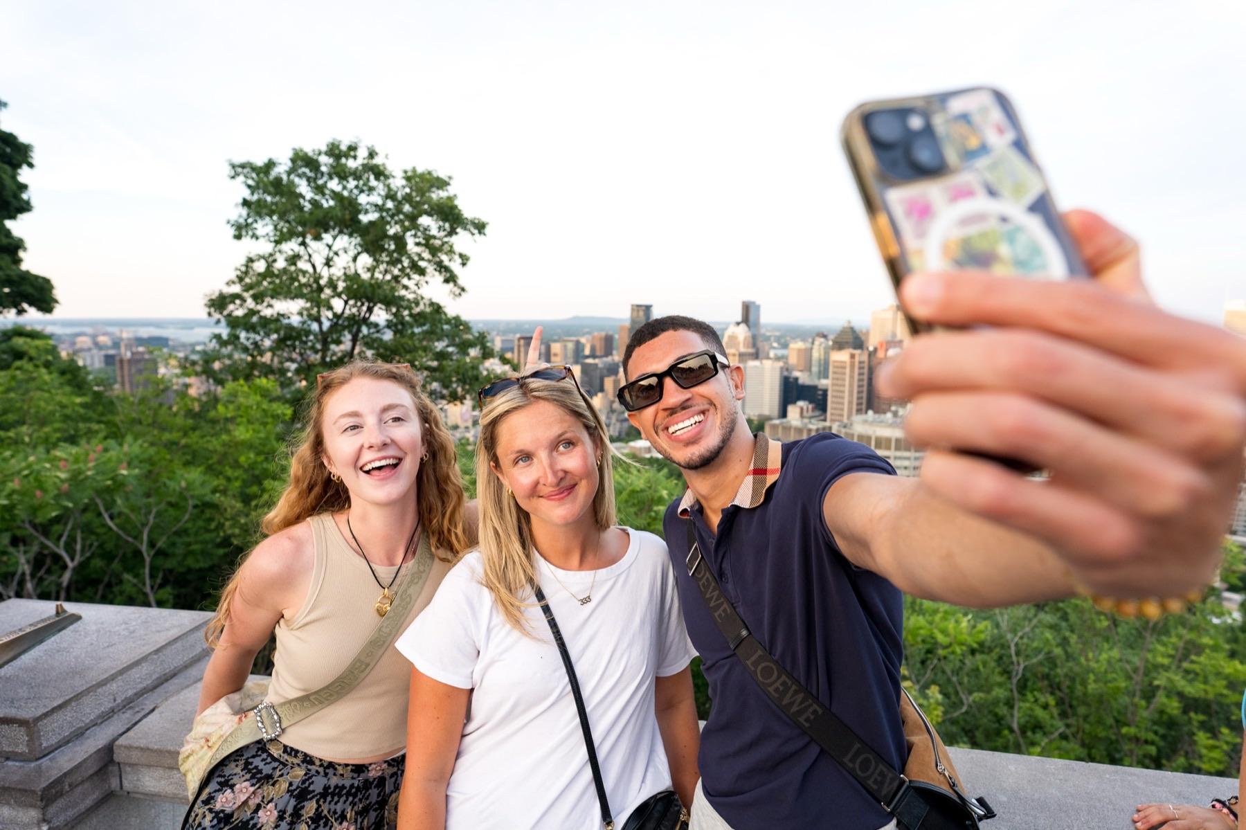 Guests take a selfie at the Mount Royal lookout above Montréal