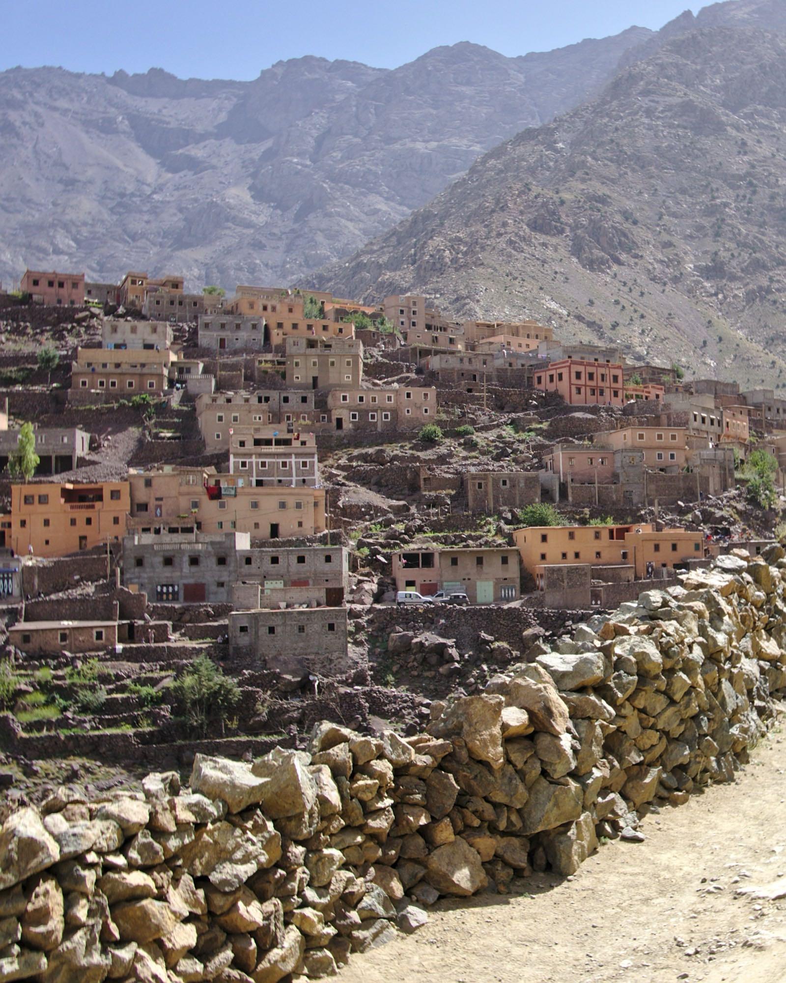The village of Aroumd climbing a slope in the Imlil valley below the bare peaks of the High Atlas