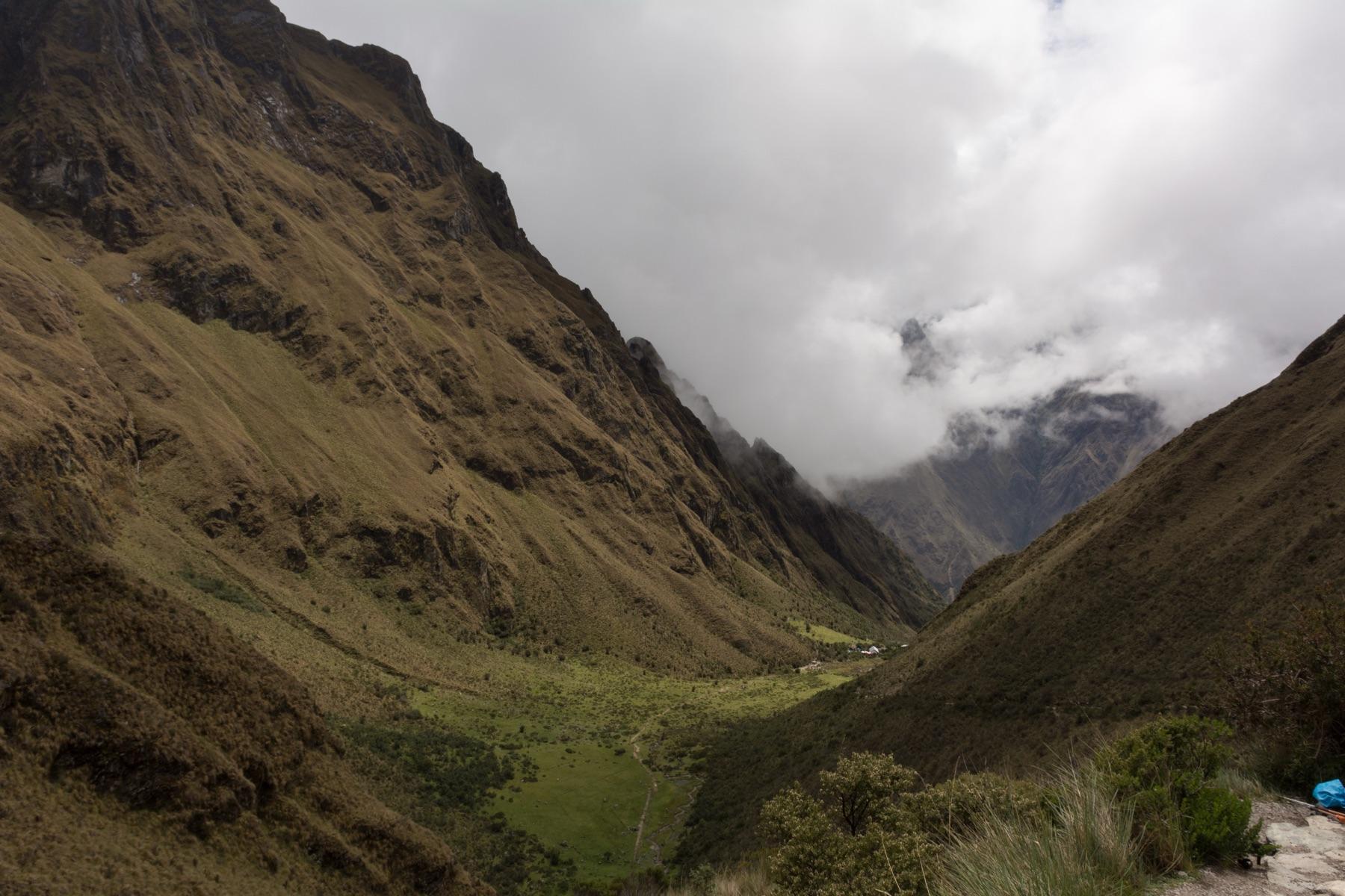 A green Andean valley seen from Dead Woman's Pass on the Inca Trail, with cloud on the peaks