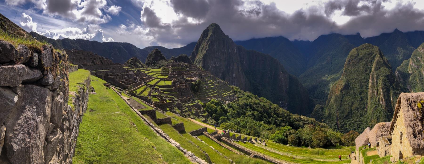 A wide view of Machu Picchu from the upper terraces, with Huayna Picchu and the surrounding peaks