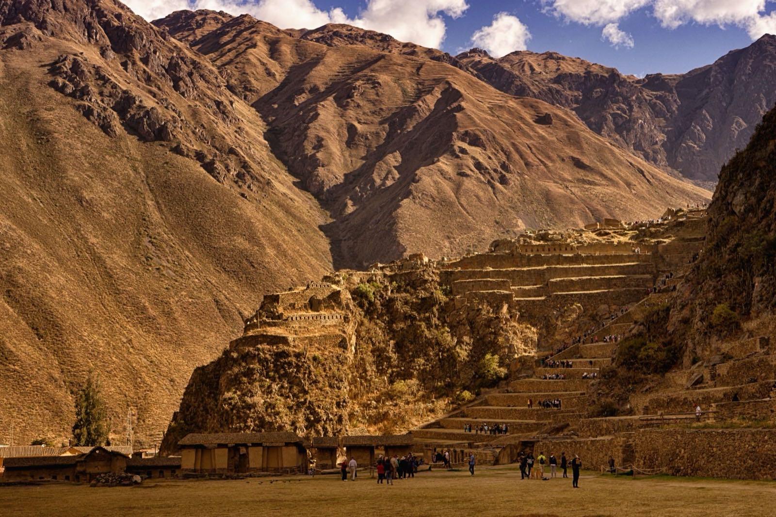 The stone terraces of the Ollantaytambo fortress climbing a hillside above the town