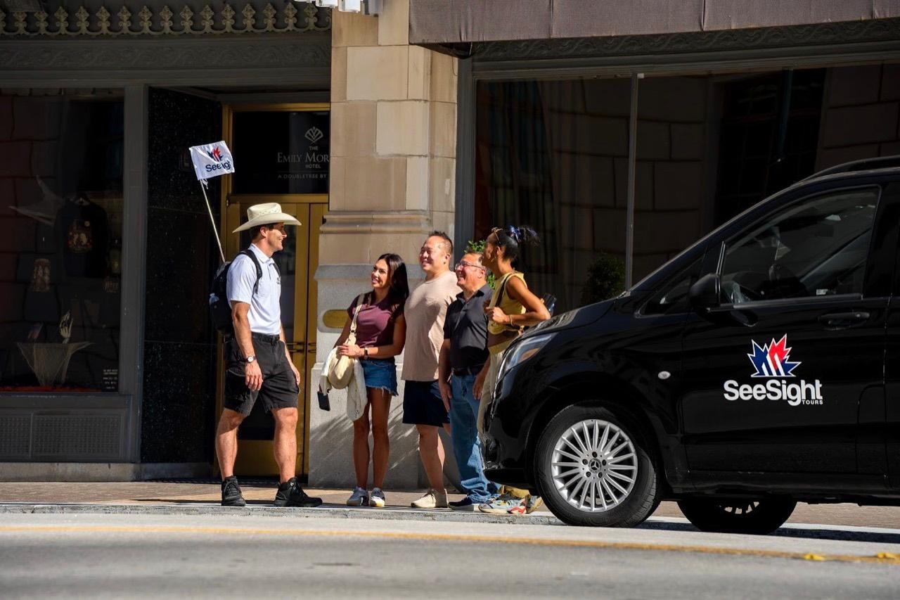 A See Sight Tours guide with guests beside the See Sight van in San Antonio