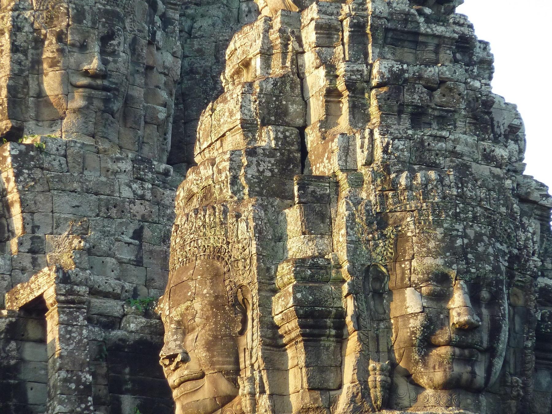 Carved stone faces on the towers of the Bayon temple in Angkor Thom