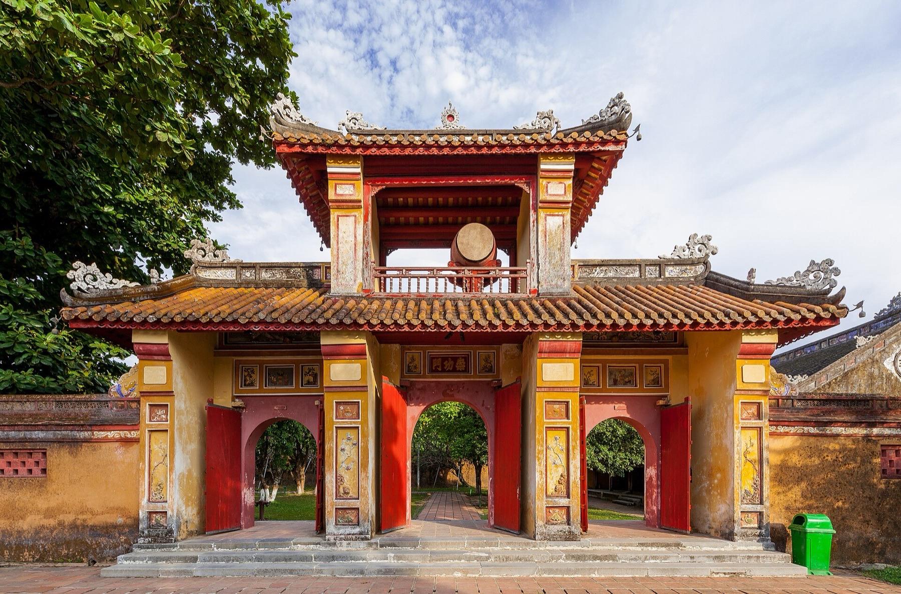 A red and gold gateway with a tiled roof inside the Imperial City of Hue