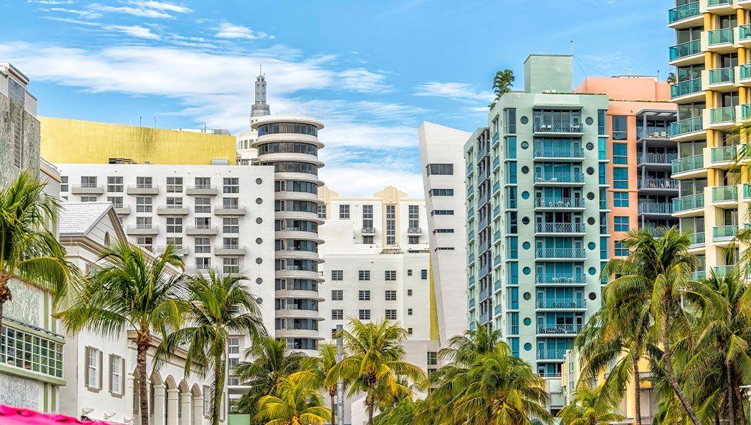 Miami-South-Beach-Ocean-Drive-road-street-with-famous-retro-art-deco-hotel-colorful-buildings-cityscape-with-palm-trees-and-blue-sky-on-sunny-day.jpg