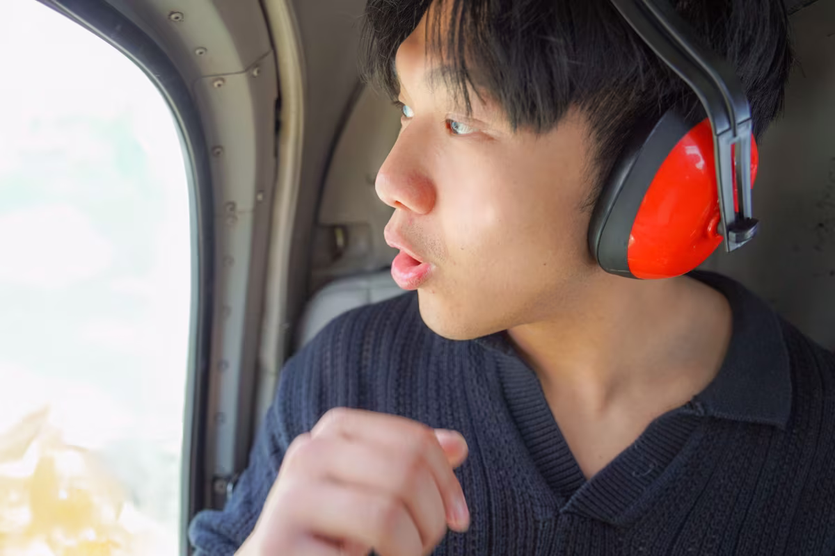 Passenger looking out of helicopter window during Niagara Falls tour.