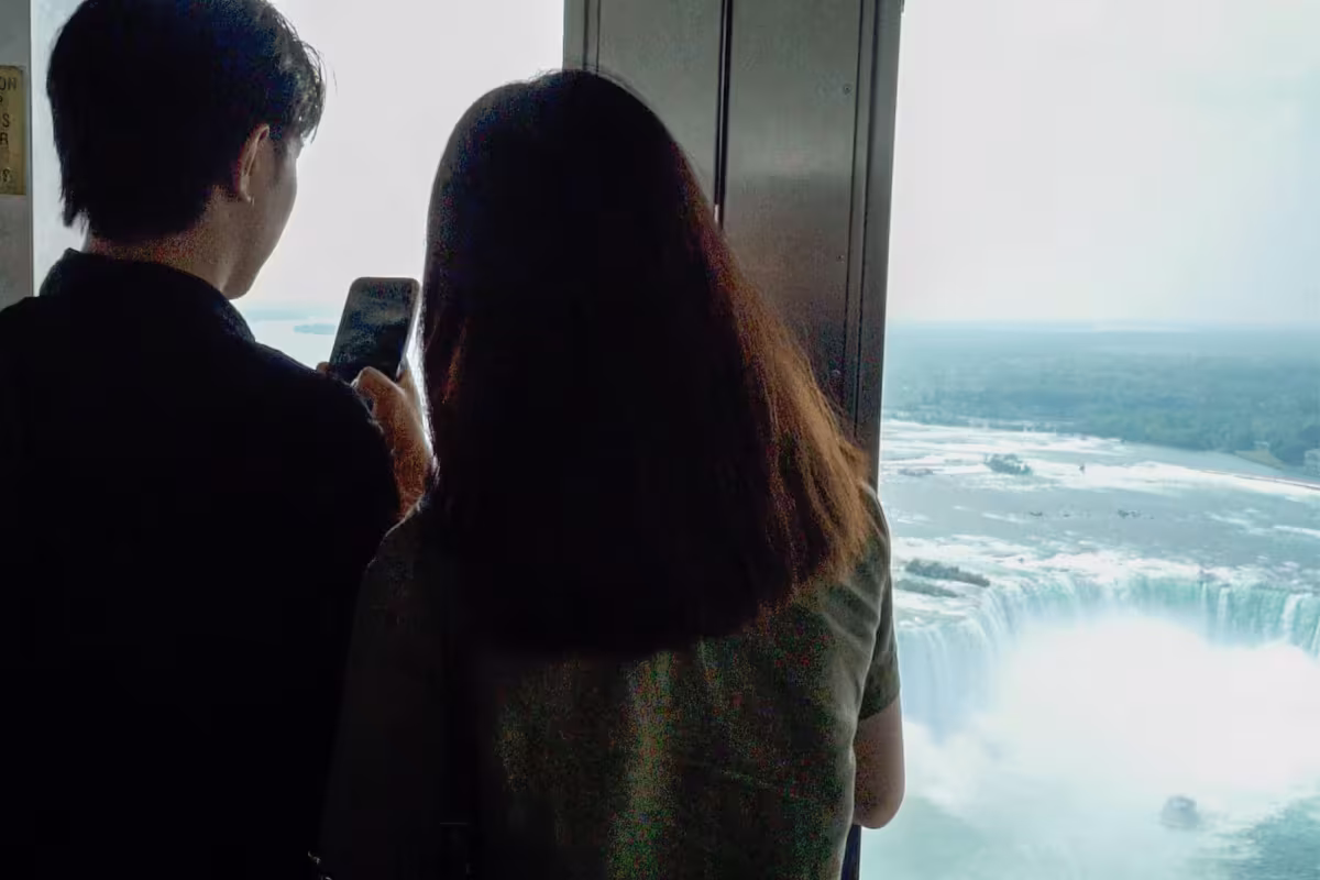 Visitors viewing Horseshoe Falls from observation window.