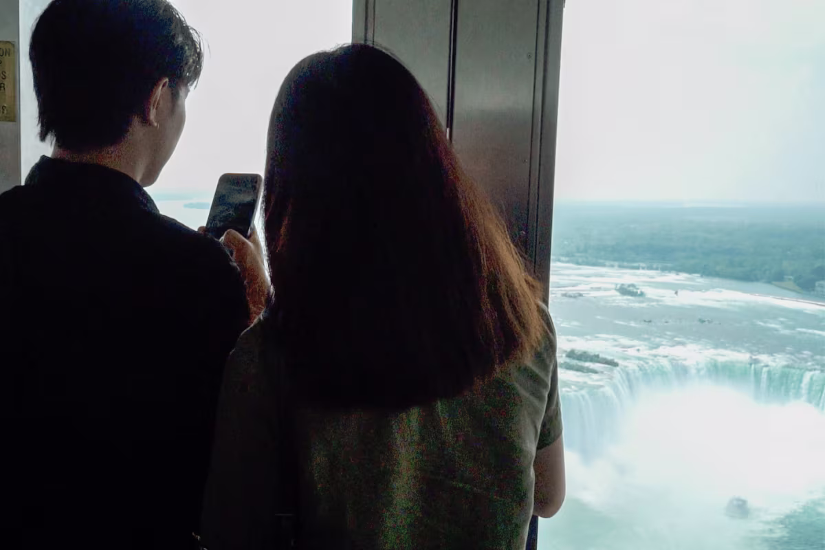 Visitors viewing Horseshoe Falls from observation window.