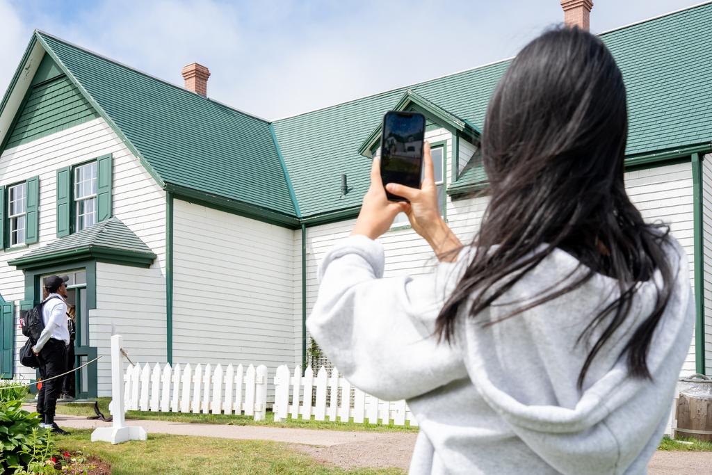 A guest photographs the Green Gables house in Cavendish
