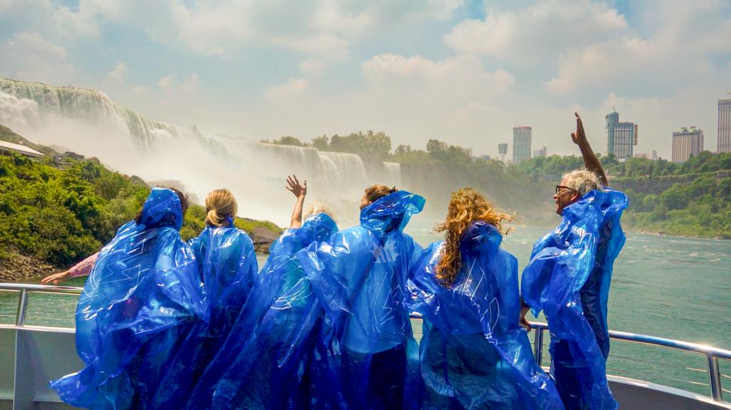 Guests in blue ponchos on the boat at the foot of Niagara Falls