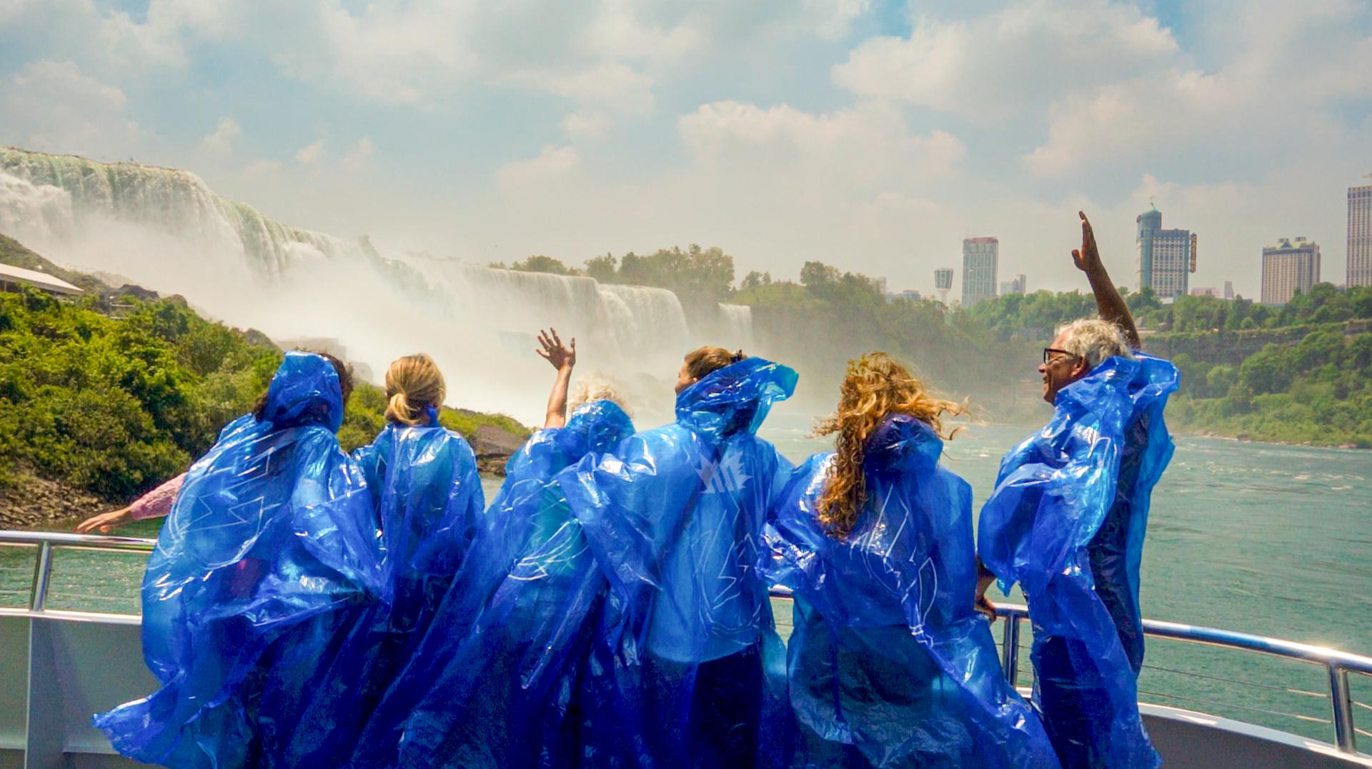 Guests in blue ponchos on the boat at the foot of Niagara Falls