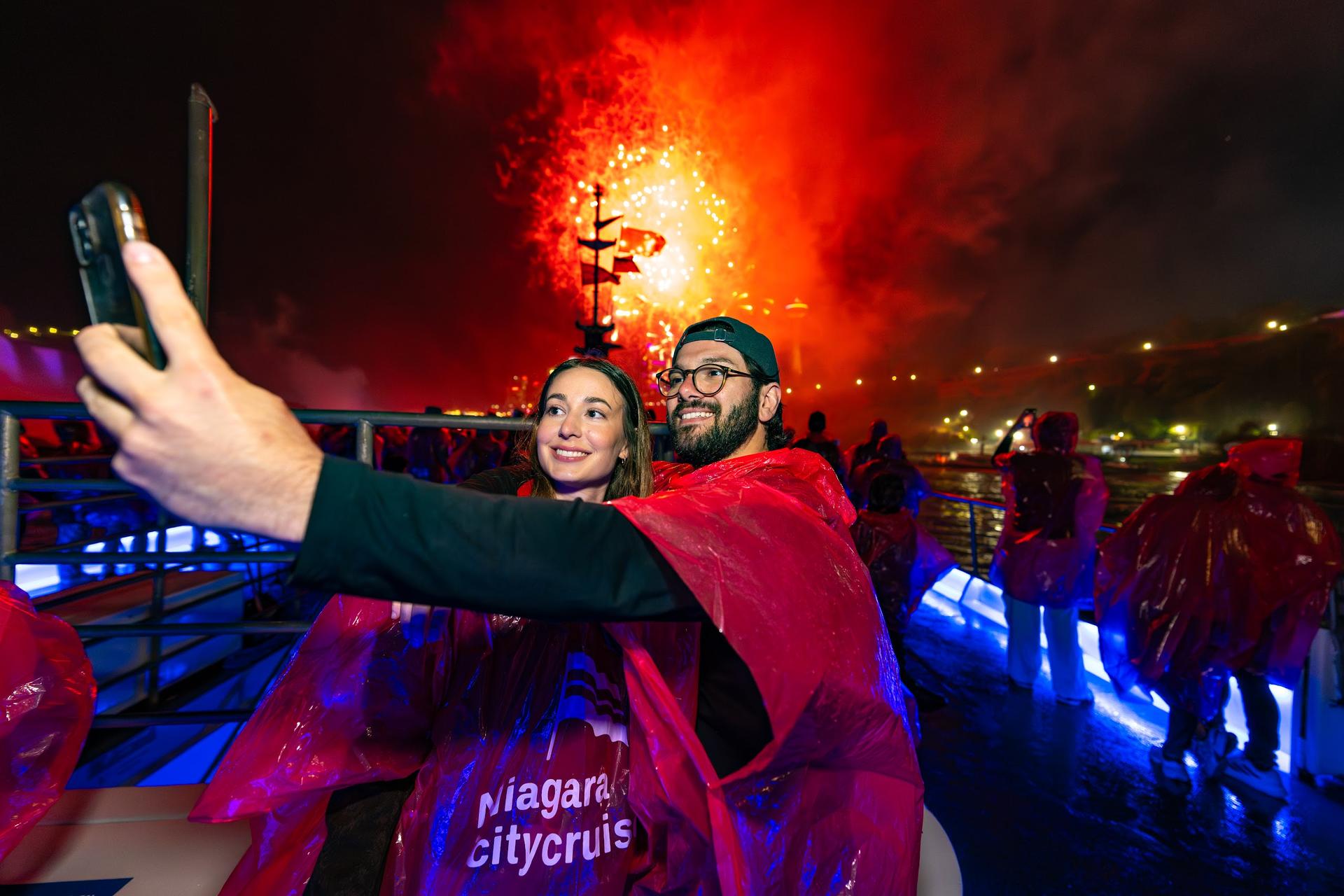 Guests take a selfie during the Niagara Falls fireworks cruise