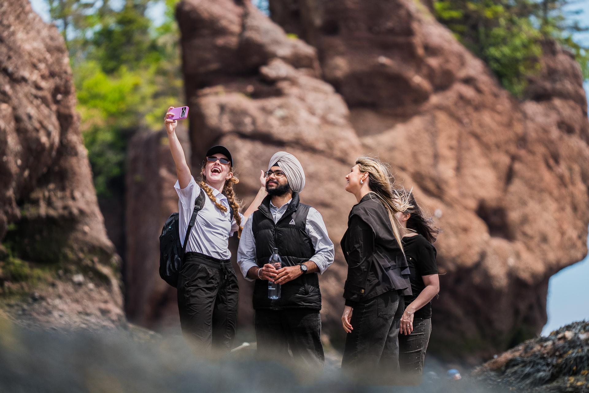 Guests take a selfie among the Hopewell Rocks flowerpot formations