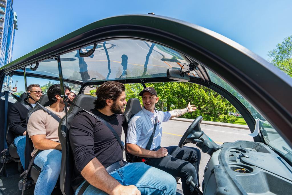 Guests ride a See Sight golf cart through Niagara Falls