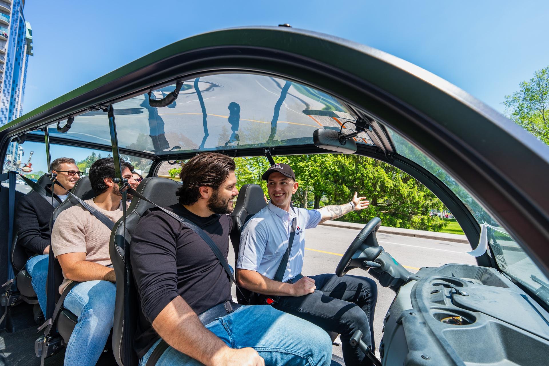 Guests ride a See Sight golf cart through Niagara Falls