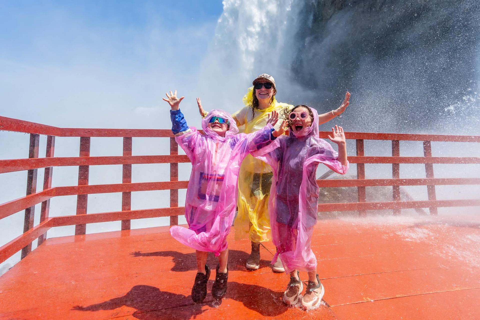 Guests in ponchos at the Hurricane Deck beside the Bridal Veil Falls