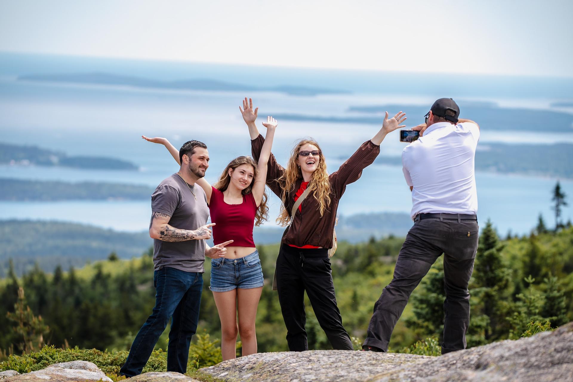 Guests cheer on top of Cadillac Mountain in Acadia National Park