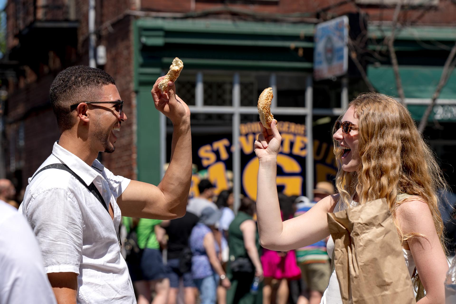 Guests with fresh bagels outside St-Viateur Bagel in Mile End