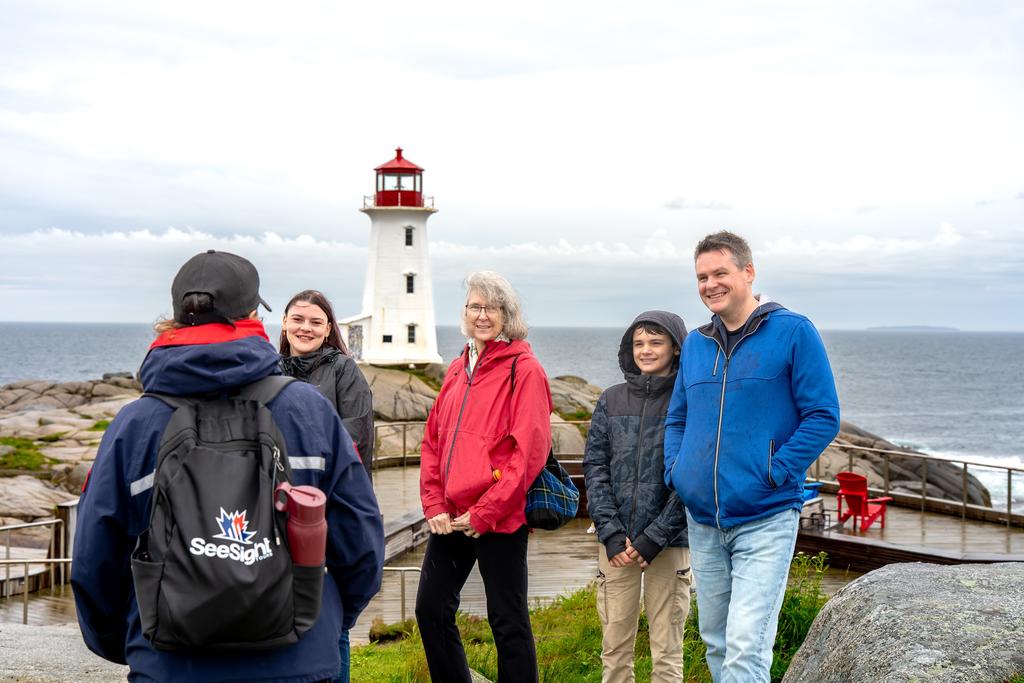 Guests with their See Sight guide at the Peggy's Cove lighthouse
