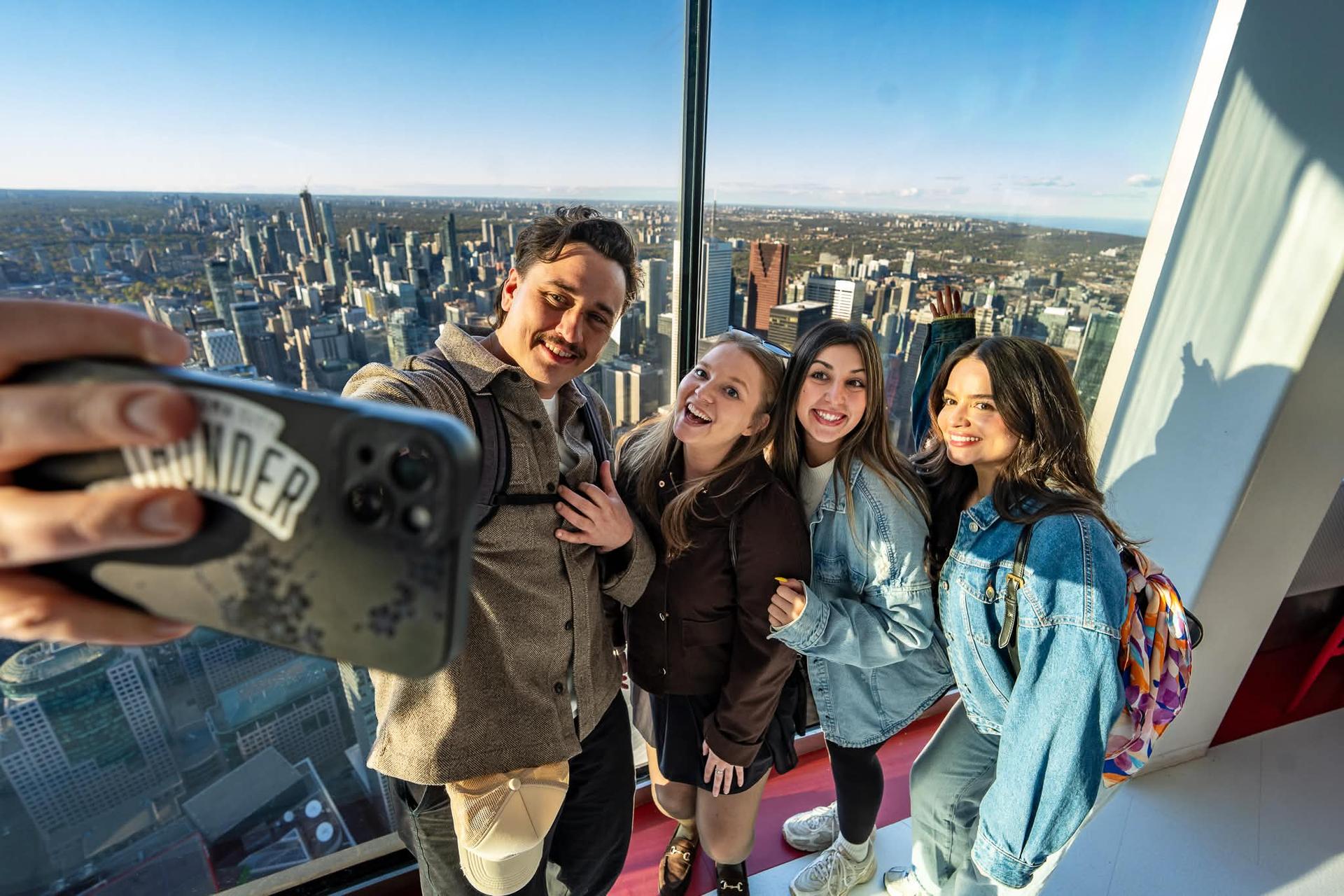 Guests take a selfie inside the CN Tower